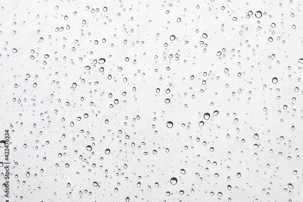 Water Drops Background. Macro view of icy rain drops on the window creating abstract geometric graphic shapes. Close Up Water Drops Background. Macro view of icy rain drops on the window creating abstract geometric graphic shapes. Close Up