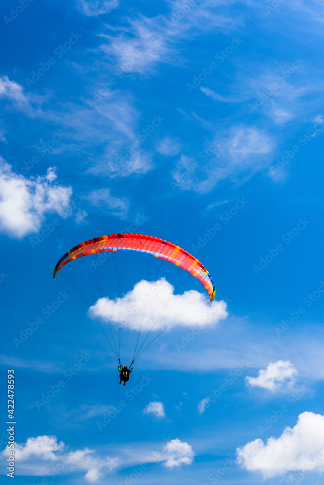 Paragliding extreme Sport with blue Sky and clouds in the background, Combining a Healthy Lifestyle and Freedom concept Paragliding extreme Sport with blue Sky and clouds in the background, Combining a Healthy Lifestyle and Freedom concept