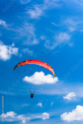 Paragliding extreme Sport with blue Sky and clouds in the background, Combining a Healthy Lifestyle and Freedom concept
