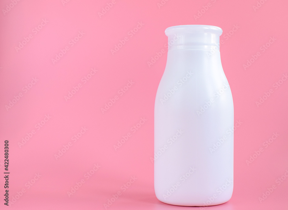 White plastic bottle for hygiene, cosmetics on a pink background. Packaging, layout, template. Copy space for text. White plastic bottle for hygiene, cosmetics on a pink background. Packaging, layout, template. Copy space for text.