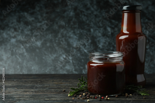 Barbecue sauce and spices on wooden table photo