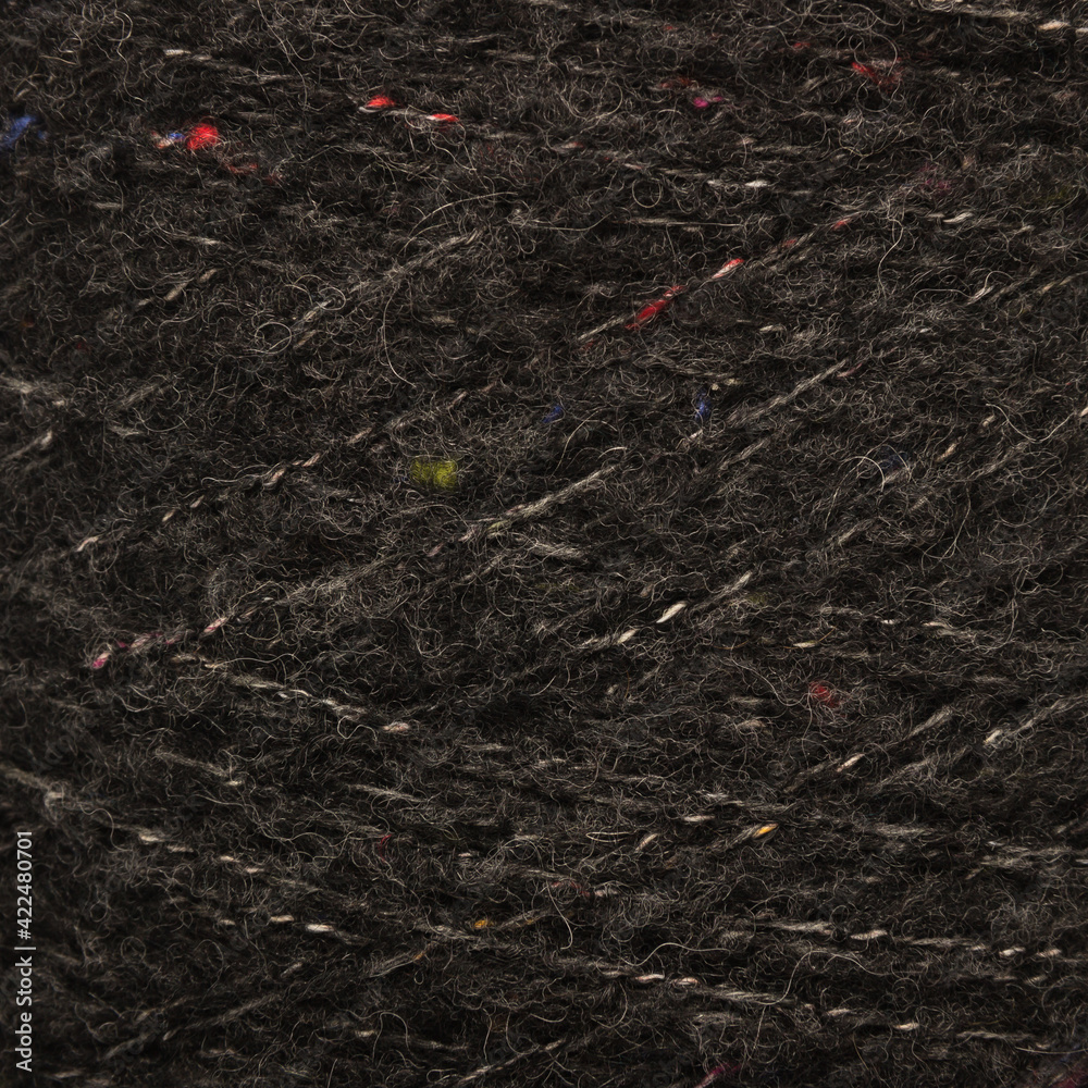 Colored yarn threads black macro Colored yarn threads black macro