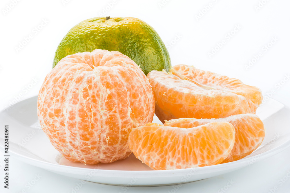 Close-up of peeled oranges isolated on a white background