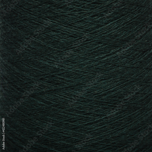 Colored yarn threads black macro