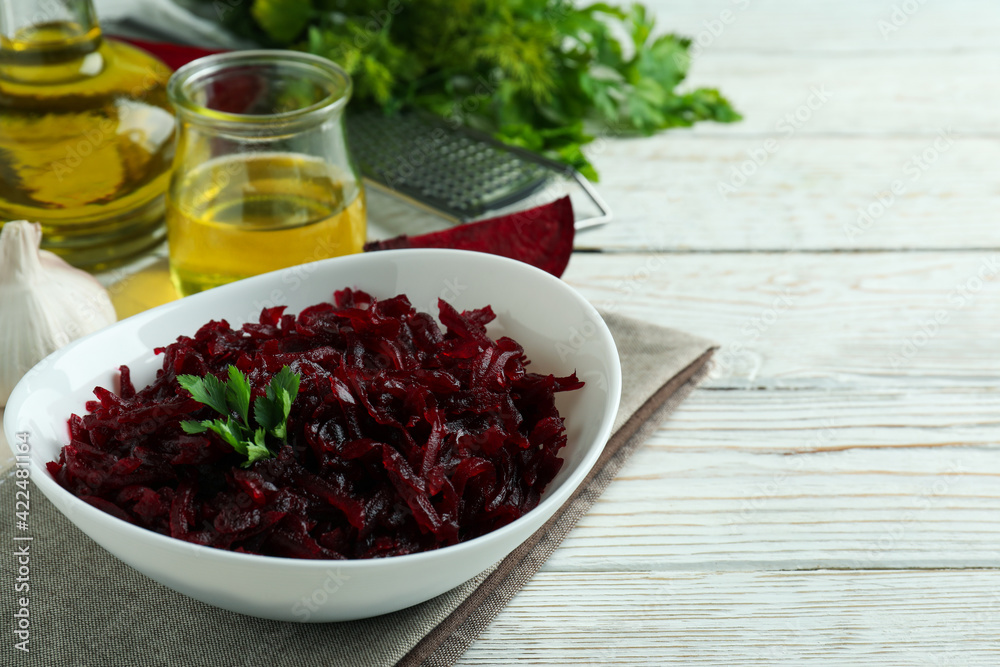 Concept of tasty eating with beet salad on white wooden background Concept of tasty eating with beet salad on white wooden background