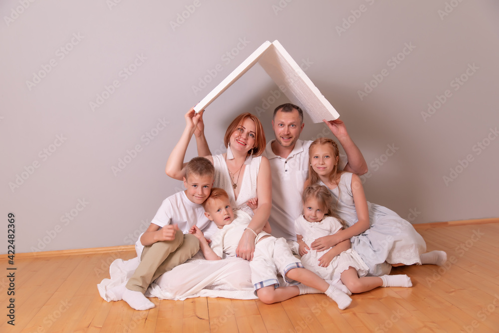 Happy young family under a safe roof, concept