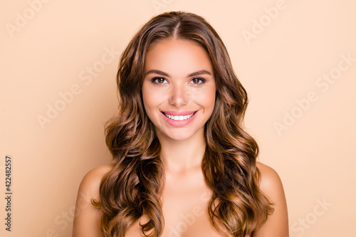 Portrait of nice long hairdo lady without clothes isolated on pastel beige color background