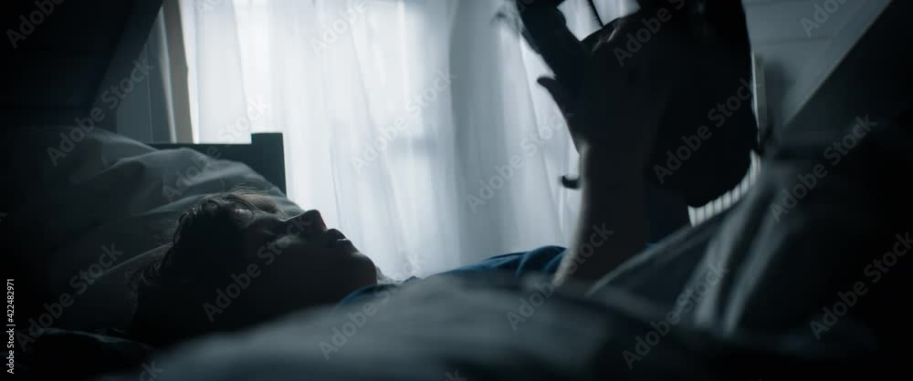 Cute little Caucasian kid boy lying on bed, playing baseball catch with himself at home. Shot with 2x anamorphic lens Cute little Caucasian kid boy lying on bed, playing baseball catch with himself at home. Shot with 2x anamorphic lens