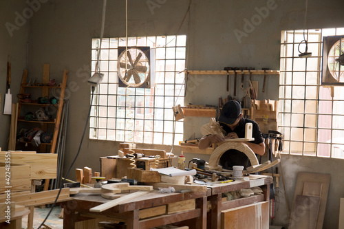Carpenter checking on rocking horse before delivery 