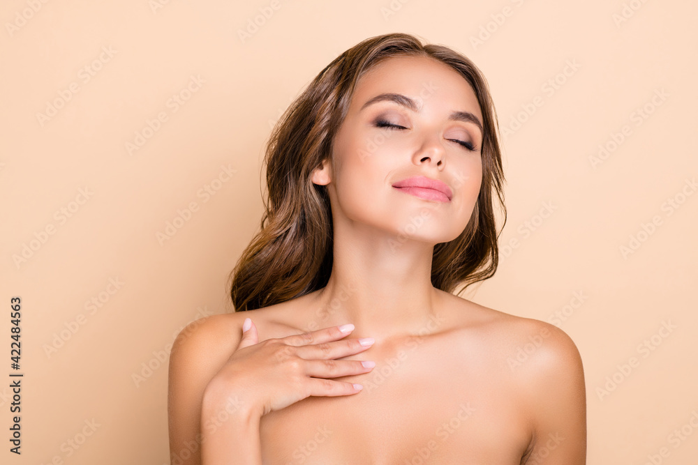 Photo of nice long hairdo optimistic lady without clothes hand neck closed eyes isolated on pastel beige color background Photo of nice long hairdo optimistic lady without clothes hand neck closed eyes isolated on pastel beige color background