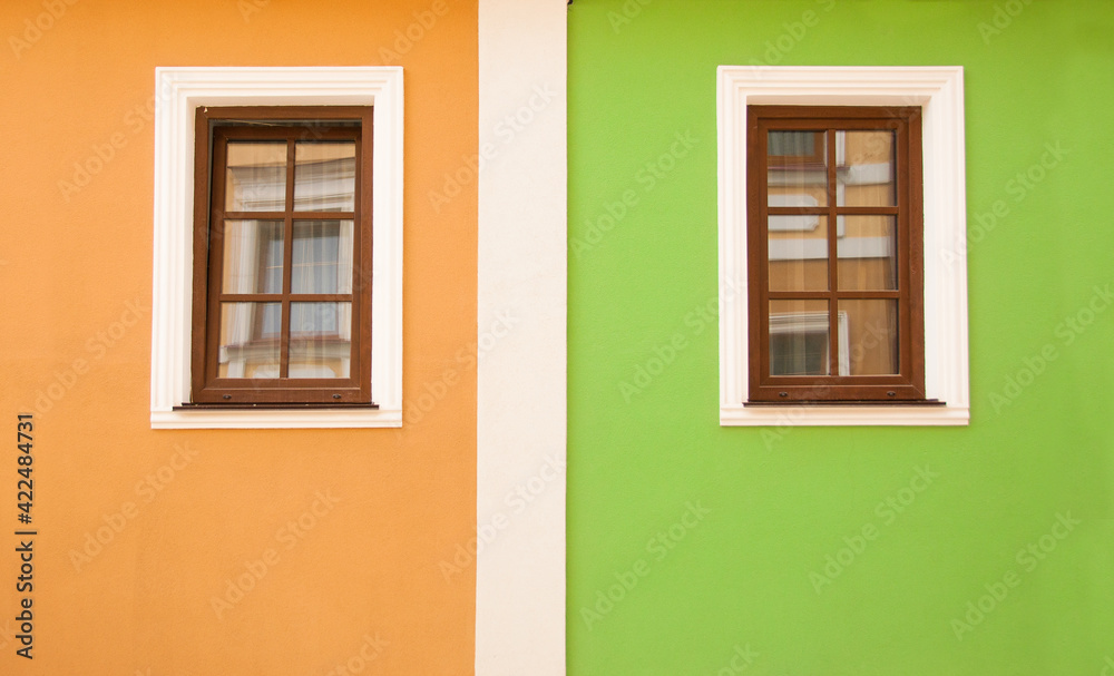 Exterior of fasade old brick houses. European countries. Magic beautiful houses with pretty windows. Building with colorful windows. Fragment of colorful house exterior. Minimalism in architecture.