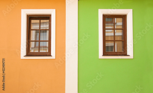 Exterior of fasade old brick houses. European countries. Magic beautiful houses with pretty windows. Building with colorful windows. Fragment of colorful house exterior. Minimalism in architecture. © Ivan