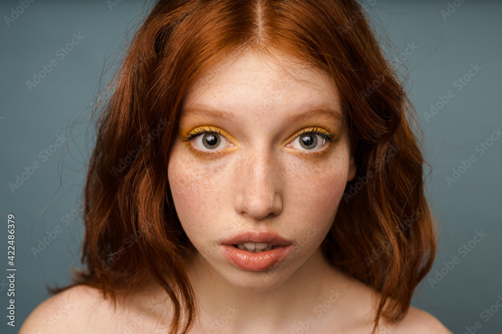 Shirtless ginger woman posing and looking at camera
