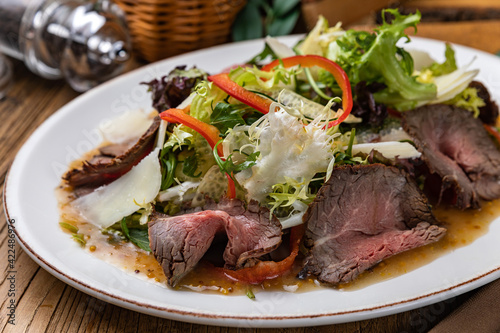 Meat salad with lettuce, pepper and parmesan 