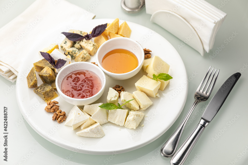 Plate with assorted cheeses and honey
