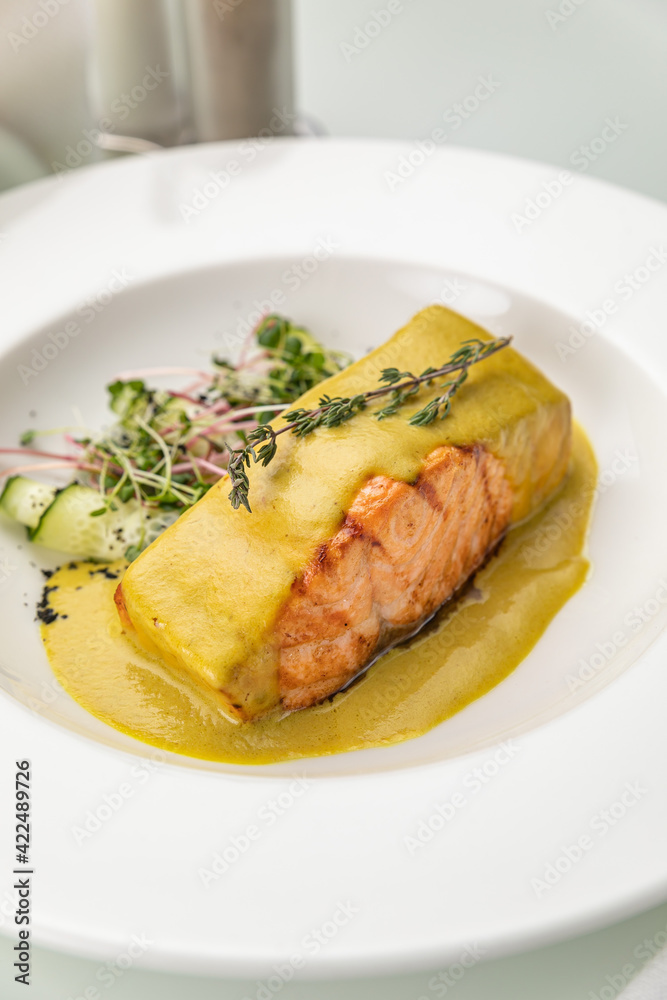 Salmon in sauce on a white plate
Salmon in sauce on a white plate