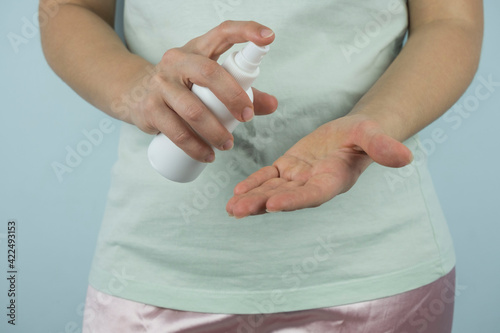 Personal Hygiene: Liquid Gel Soap Hand Sanitizer Pouring from Bottle into a Woman's Hand isolated