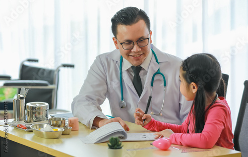 Ethnic doctor communicating with child patient