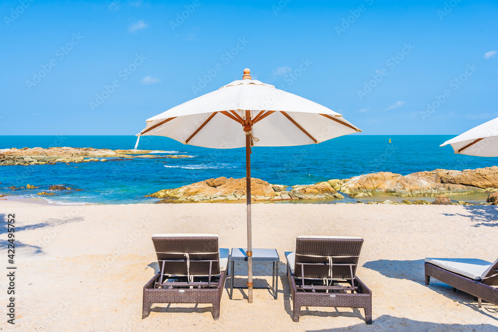 Beautiful tropical beach sea with umbrella and chair around white cloud and blue sky