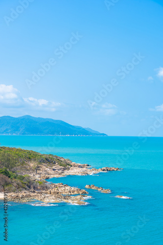 Beautiful high view tropical sea ocean with white cloud blue sky © siraphol