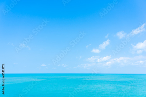 Beautiful high view tropical sea ocean with white cloud blue sky © siraphol