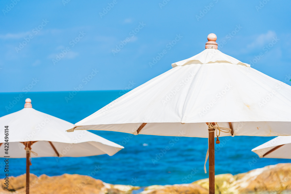 Beautiful tropical beach sea with umbrella and chair around white cloud and blue sky Beautiful tropical beach sea with umbrella and chair around white cloud and blue sky