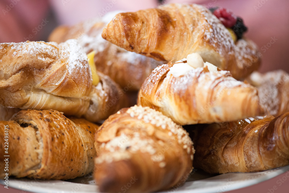 Freshly baked croissants on a plate with different fillings. Freshly baked croissants on a plate with different fillings.