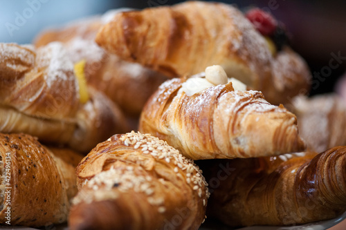 Freshly baked croissants on a plate with different fillings.