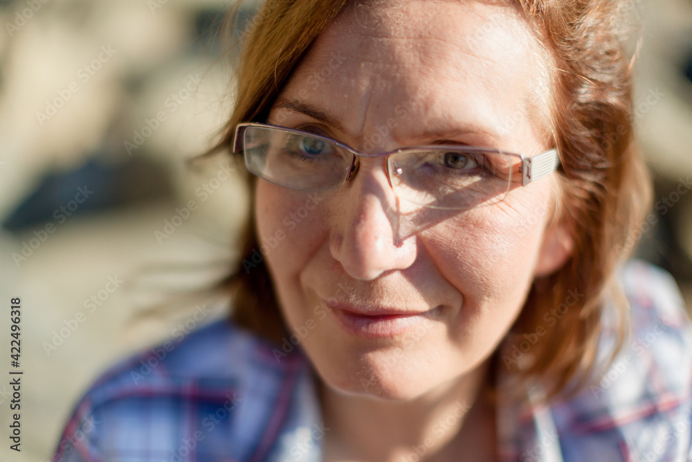 Portrait of happy mature woman wearing eyeglasses and looking at camera. Closeup face of smiling beautiful maddle aged natural woman. Retired blondy person in casuals Portrait of happy mature woman wearing eyeglasses and looking at camera. Closeup face of smiling beautiful maddle aged natural woman. Retired blondy person in casuals