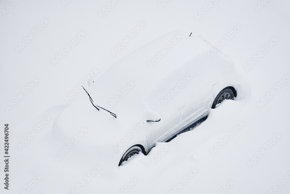 Snow-covered car on the parking place after the strong snowstorm