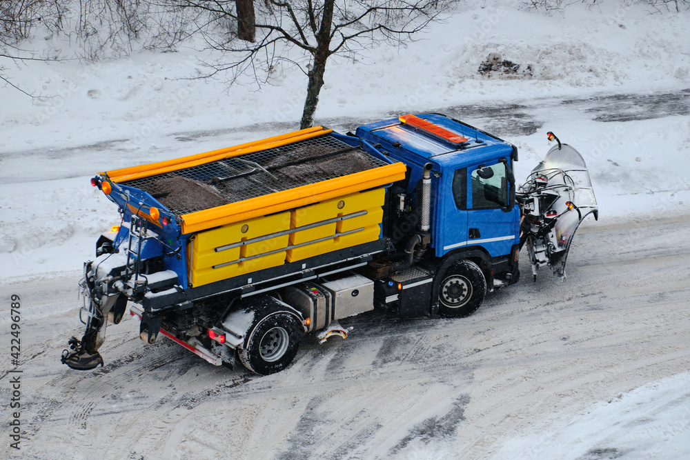 Snowplow is clearing the street during a snowstorm in Finland.