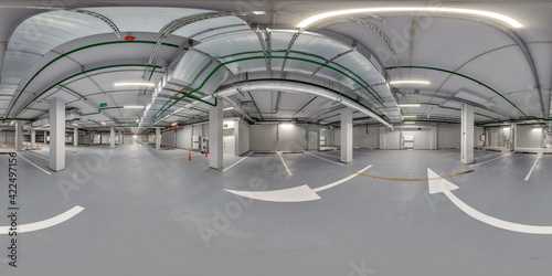 Full  spherical hdri panorama 360 degrees in empty underground garage parking with columns and road markings in equirectangular projection   VR content