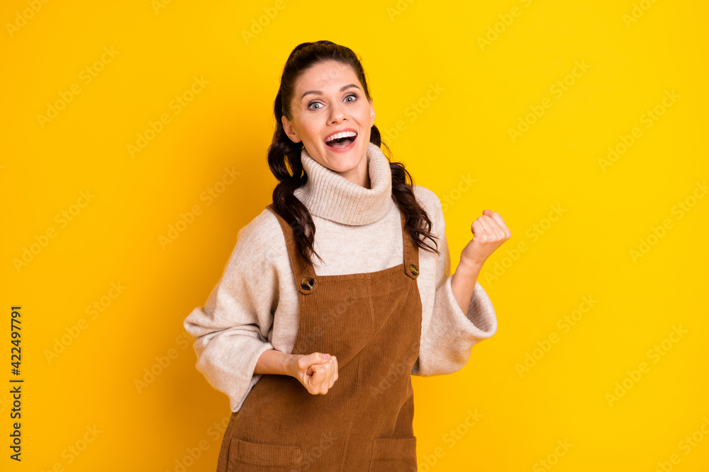 Photo of nice brunette hooray curly hairdo lady hands fists wear sweater isolated on yellow color background