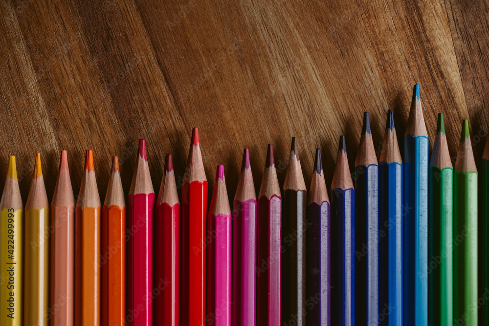 Colored pencils on wooden background. Back to school and education concept. Colored pencils on wooden background. Back to school and education concept.
