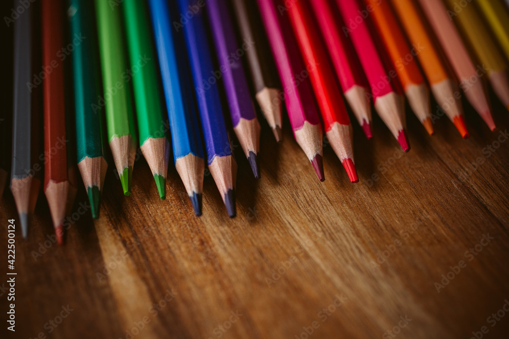 Colored pencils on wooden background. Back to school and education concept. Colored pencils on wooden background. Back to school and education concept.