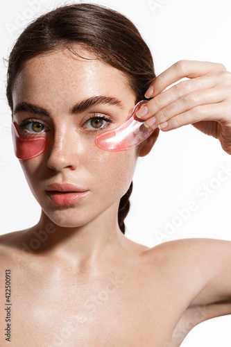 Tableau sur toile Vertical beauty shot of young model with clean hydrated, moisturized skin using
