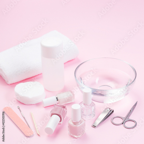 Manicure or pedicure equipment with nail coat or polish  spa set  on pink background  square