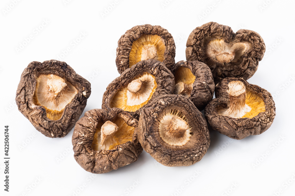 Close-up of dried shiitake mushrooms isolated on white background.