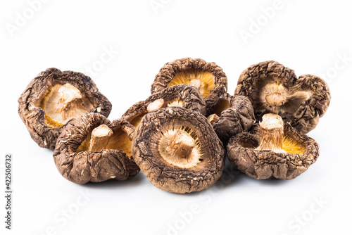 Close-up of dried shiitake mushrooms isolated on white background.