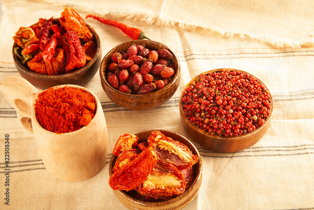Red colored food. Dried healthy food spices. Dried tomatoes, dried peppers, rosehips, red pepper seeds, red pepper. Red colored food. Dried healthy food spices. Dried tomatoes, dried peppers, rosehips, red pepper seeds, red pepper.