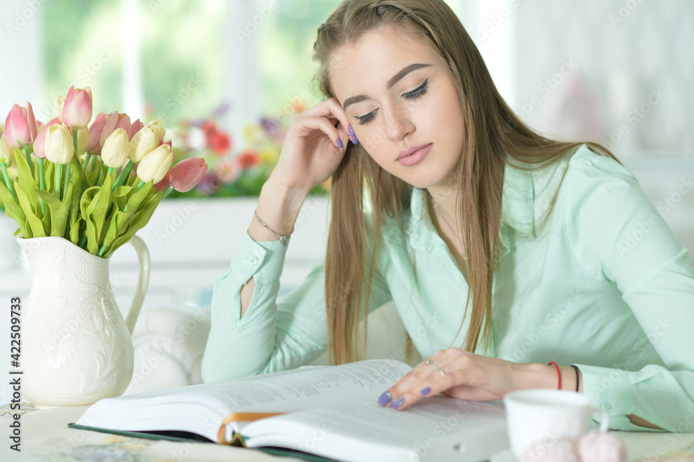 Young attractive woman with book and cup of coffee Young attractive woman with book and cup of coffee