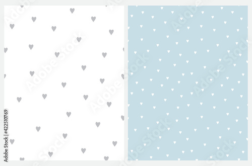 Cute Hand Drawn Irregular Romantic Vector Patterns with Tiny Hearts Isolated on a Light Blue and White Background. Funny Infantile Style Hearts Print.