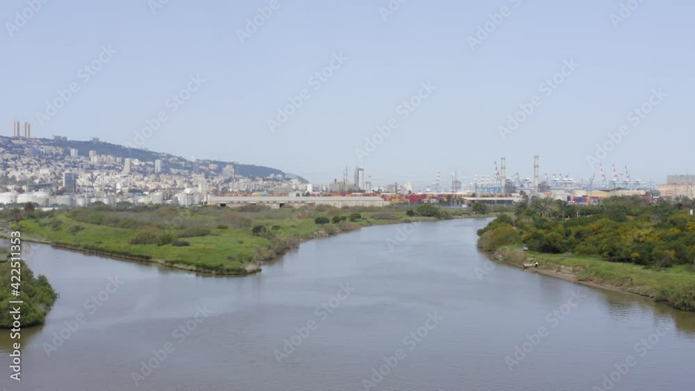 Haifa Kishon river stream with the city port in the horizon, Aerial view. Haifa Kishon river stream with the city port in the horizon, Aerial view.