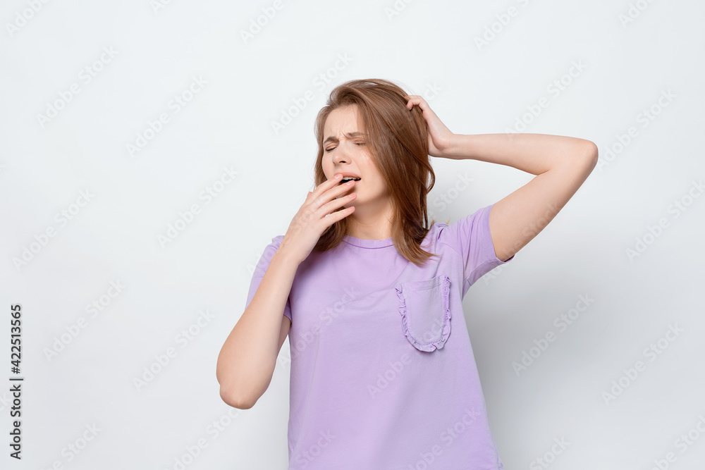 Portrait of tired girl, lacking sleep, feeling fatigue or boredom, yawn and cover yawning mouth Portrait of tired girl, lacking sleep, feeling fatigue or boredom, yawn and cover yawning mouth