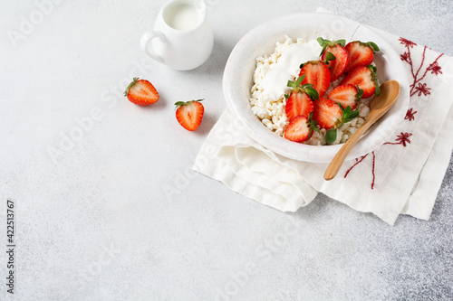 Cottage cheese, curd cheese with strawberries berries in a bowl, ogranic homemade dairy product. Healthy dairy product rich in Calcium and Protein. photo