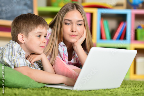 brother and sister playing computer