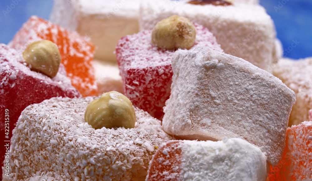 Turkish delight on blue wooden background Turkish delight on blue wooden background