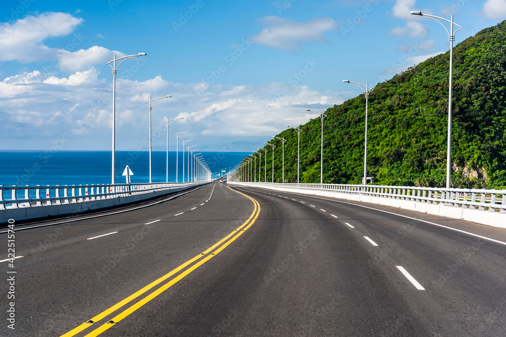 Fototapeta premium Asphalt road with blue sky in the countryside of Taitung, Taiwan.