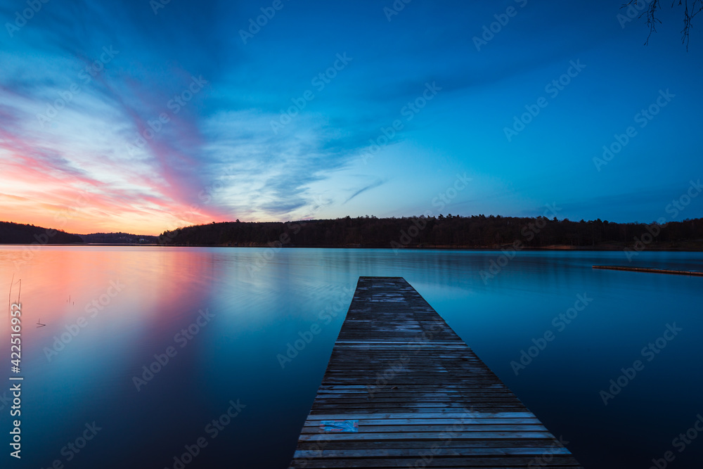 Fototapeta Drewniany pomost nad jeziorem podczas wschodu słońca