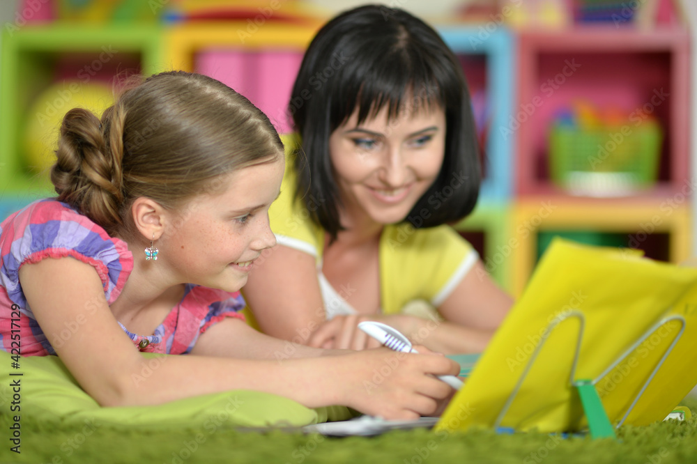 little cute girl and mother doing homework at home little cute girl and mother doing homework at home